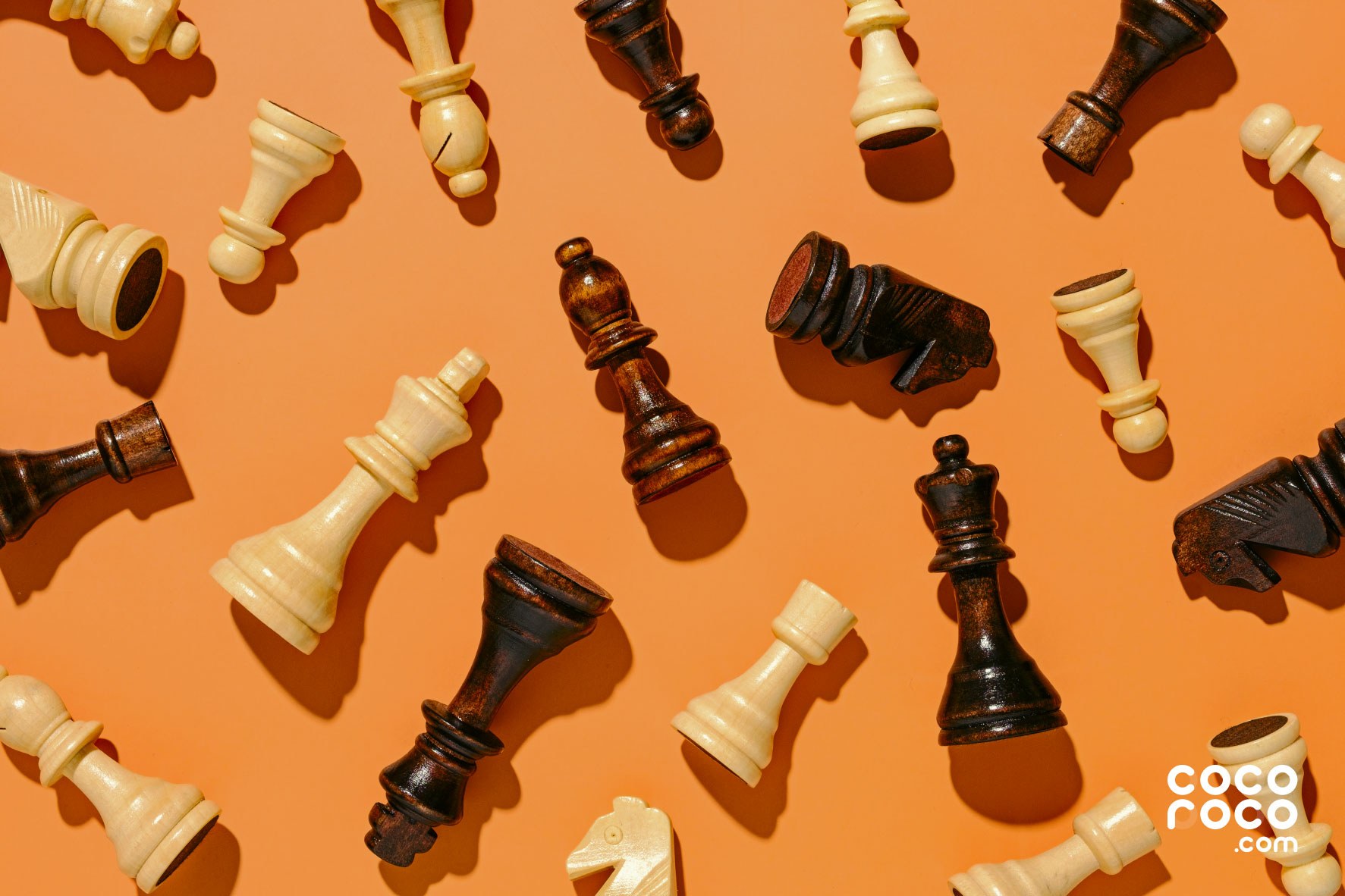An image of chess pieces with an orange background